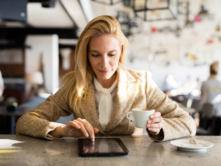 kobieta czyta tablet przy stole
